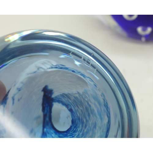 711 - A collection of glass paperweights including Caithness and a small glass rhinoceros