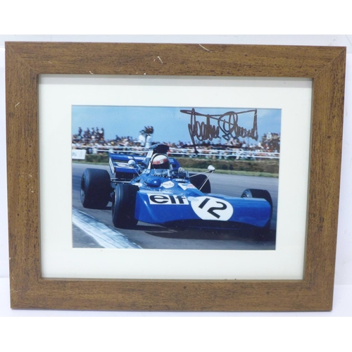 722 - A framed photograph of Jackie Stewart, signed