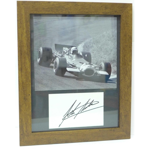 727 - A framed photograph of John Surtees with mounted autograph