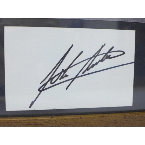 727 - A framed photograph of John Surtees with mounted autograph