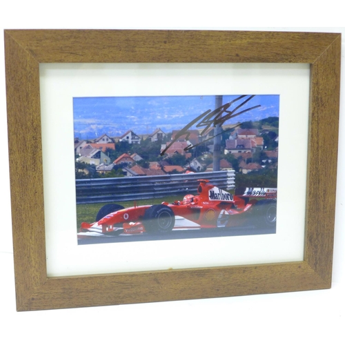 728 - A framed photograph of Michael Schumacher, signed