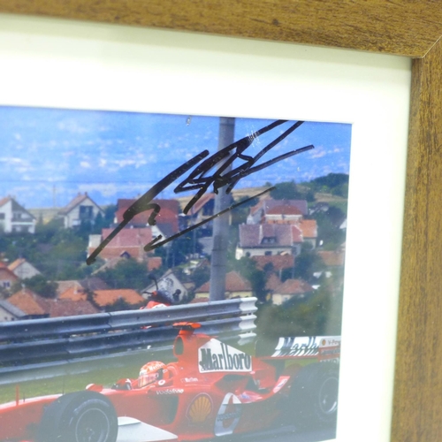 728 - A framed photograph of Michael Schumacher, signed