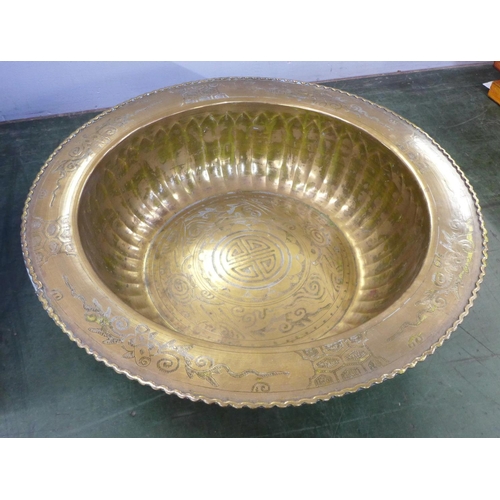 794 - A large Eastern brass bowl with emblems, 47cm