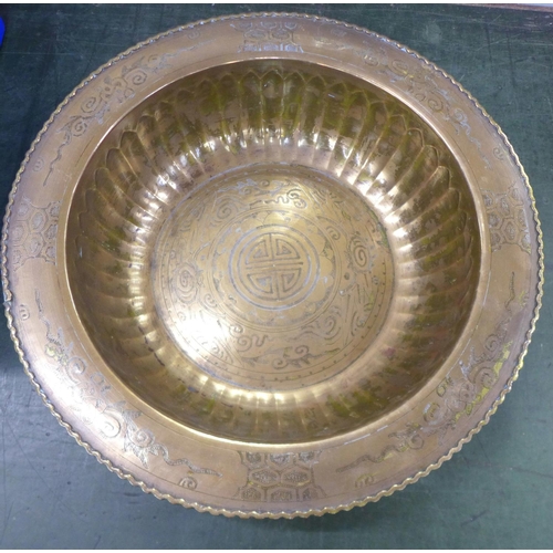 794 - A large Eastern brass bowl with emblems, 47cm