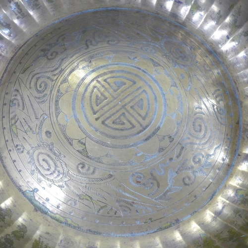 794 - A large Eastern brass bowl with emblems, 47cm