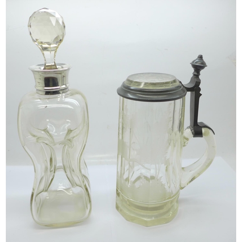 802 - A silver mounted decanter, a/f, and an etched glass tankard