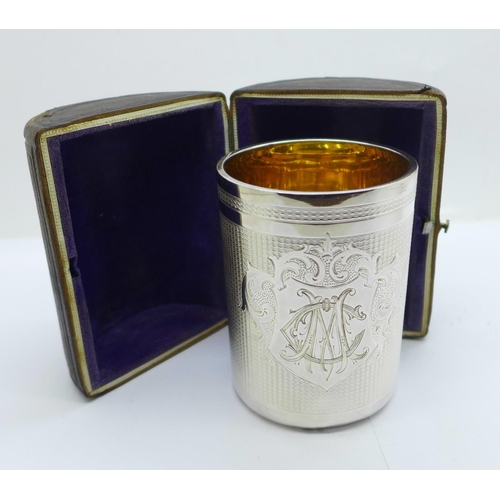 813 - A white metal goblet with monogram and gilt interior, with case, marked 750H, 136g