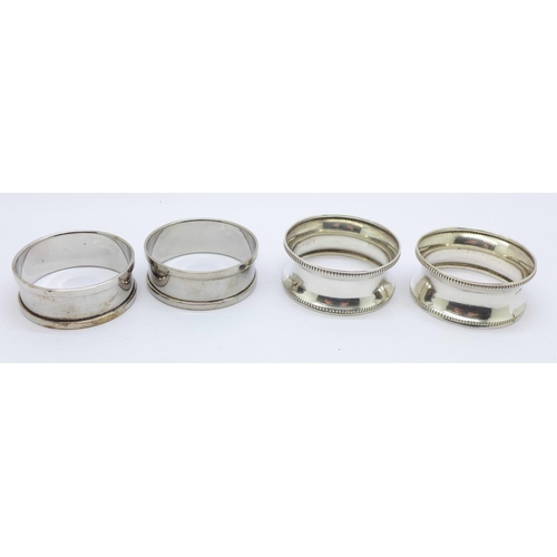 823 - Two pairs of silver napkin rings, Francis and Webb, Birmingham 1945, 12g, and Henry Griffith and Son... 