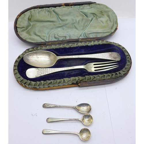 830 - A Victorian silver fork and spoon christening set, cased, and a set of three silver condiment spoons... 