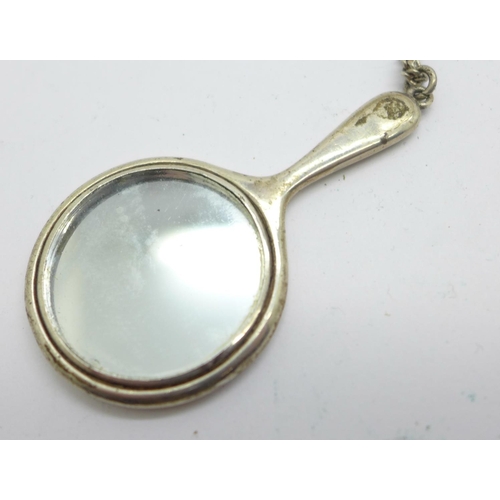 856 - A miniature silver hand mirror, Birmingham 1921, on a silver chain