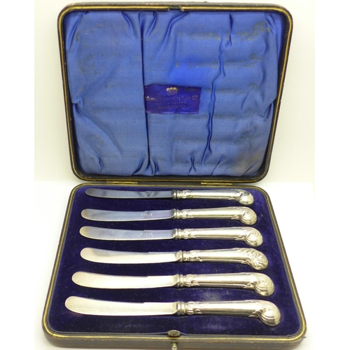 861 - A cased set of silver handled butter knives with pistol grips