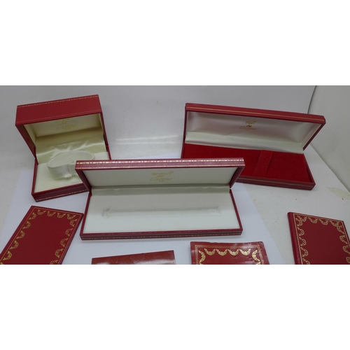 870 - Three Cartier boxes and booklets, (two pen, one watch)