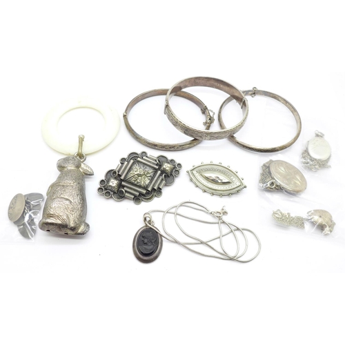 897 - Three silver bangles, three silver lockets, two brooches, a pendant, cufflinks and a rattle