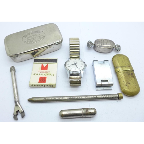 899 - A silver pill box in the form of a wrapped sweet, a Sekonda wristwatch, a lighter, a magnifying glas... 