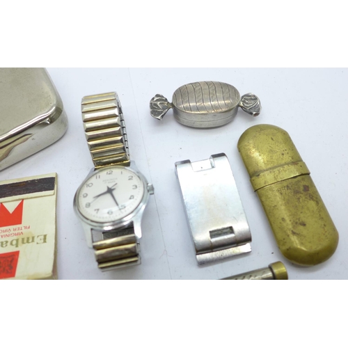 899 - A silver pill box in the form of a wrapped sweet, a Sekonda wristwatch, a lighter, a magnifying glas... 