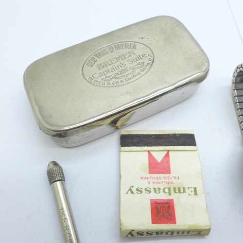 899 - A silver pill box in the form of a wrapped sweet, a Sekonda wristwatch, a lighter, a magnifying glas... 