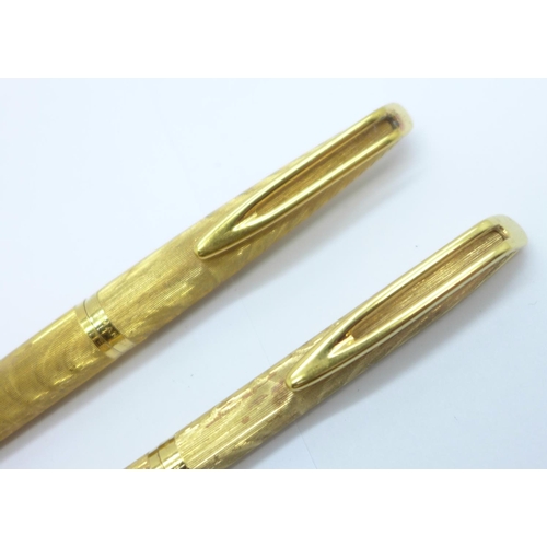 908 - A gold plated Waterman pen and pencil set, the pen with 18ct gold nib