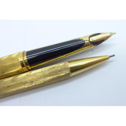 908 - A gold plated Waterman pen and pencil set, the pen with 18ct gold nib