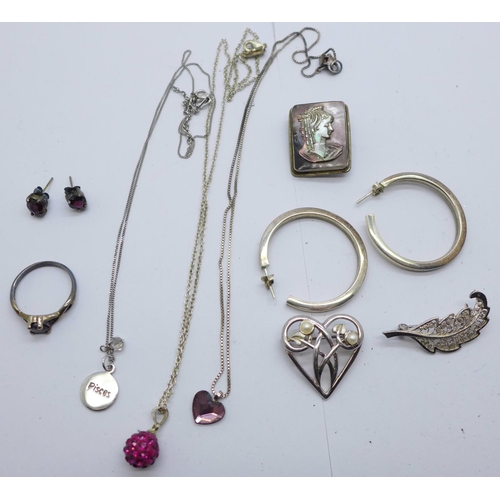 918 - Three silver brooches, a silver and garnet ring with matching earrings, silver pendants, etc.