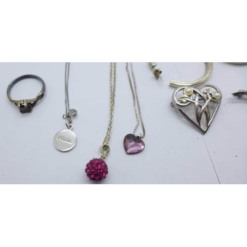 918 - Three silver brooches, a silver and garnet ring with matching earrings, silver pendants, etc.