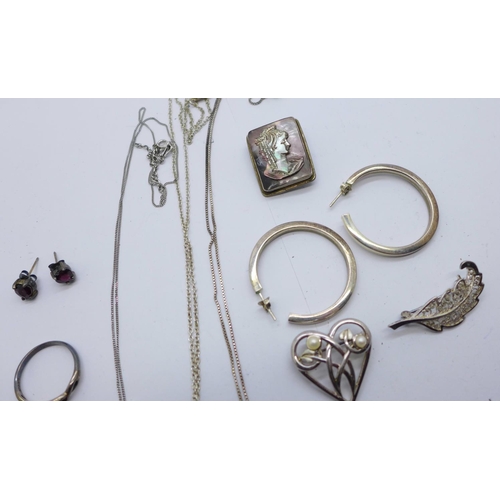 918 - Three silver brooches, a silver and garnet ring with matching earrings, silver pendants, etc.