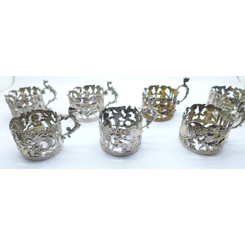 930 - Seven silver glass beaker holders, various makers, 201g