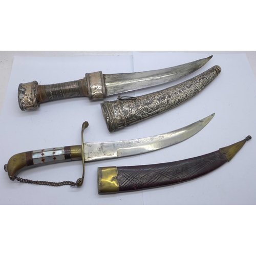 942 - Two Eastern daggers with scabbards, one with mother of pearl handle