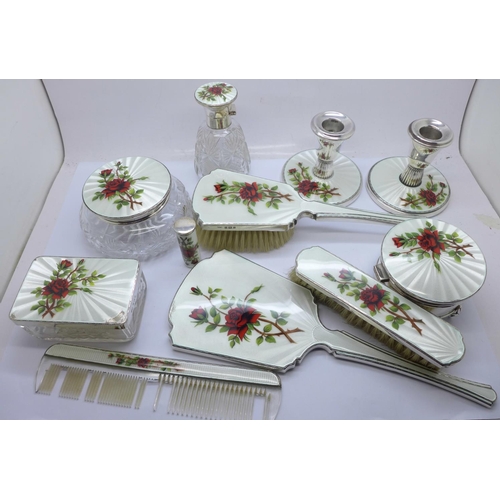 946A - A silver and guilloche enamel dressing table set, includes a pair of dwarf candlesticks, cheroot hol... 