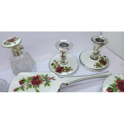 946A - A silver and guilloche enamel dressing table set, includes a pair of dwarf candlesticks, cheroot hol... 