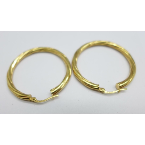 976 - A pair of 9ct gold earrings, 2.4g, 33mm diameter