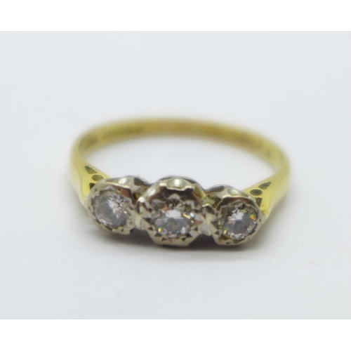 987 - An 18ct gold, three stone diamond ring, 3.2g, R