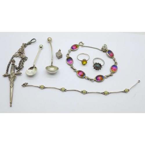 991 - Two silver salt spoons, two rings, a part chatelaine, a silver bracelet, fastener requires repair, a... 