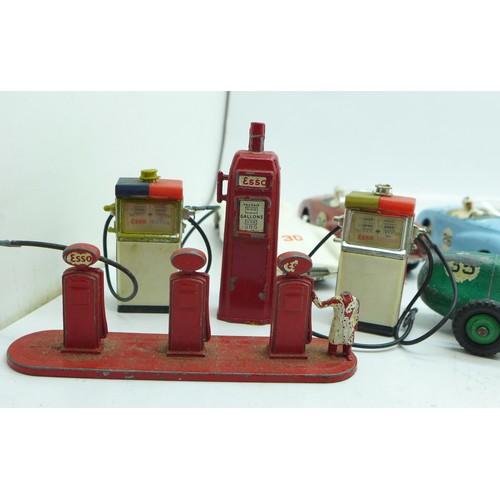 785 - Thirteen Dinky Toys die-cast vehicles and four petrol pumps