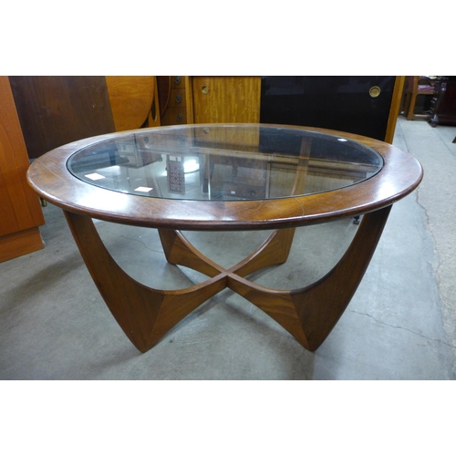 122 - A G-Plan Astro teak and glass topped circular coffee table (glass chipped)