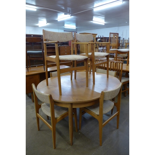 126 - A teak extending dining table and six Eric Buch dining chairs