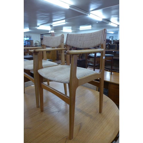 126 - A teak extending dining table and six Eric Buch dining chairs