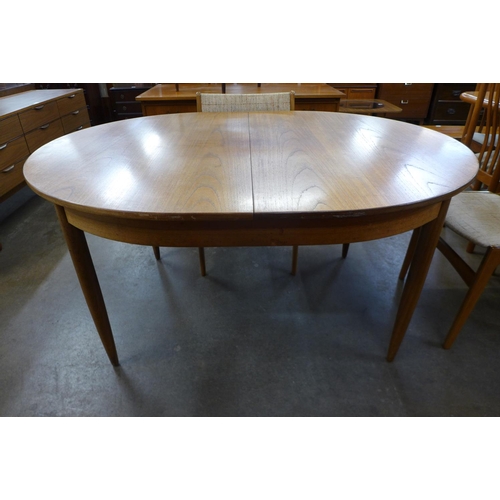 126 - A teak extending dining table and six Eric Buch dining chairs