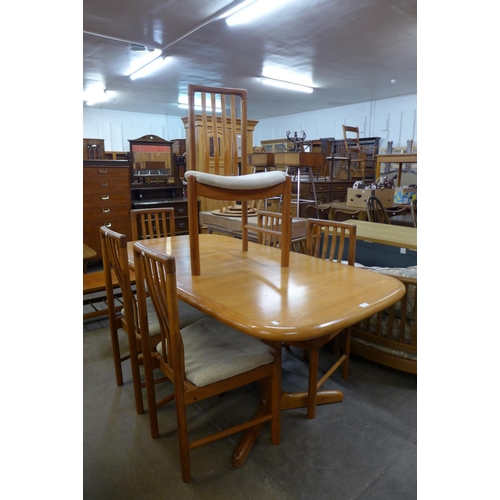 127 - A teak extending dining table and six chairs