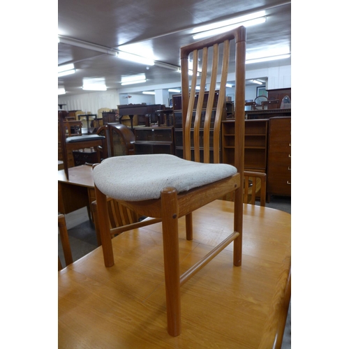 127 - A teak extending dining table and six chairs