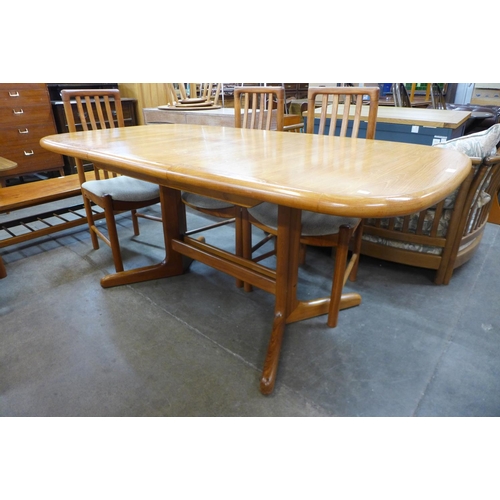 127 - A teak extending dining table and six chairs