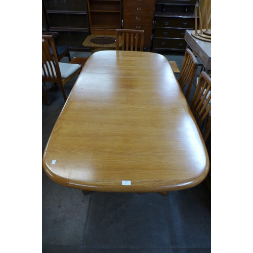 127 - A teak extending dining table and six chairs