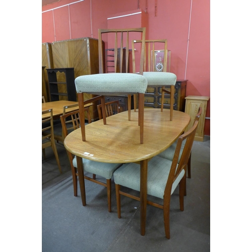 128 - A teak extending dining table and six chairs