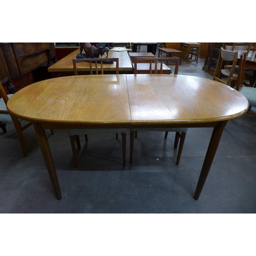 128 - A teak extending dining table and six chairs