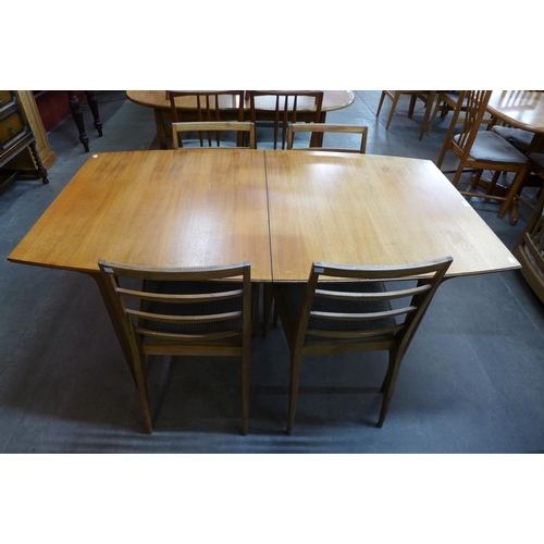 129 - A McIntosh teak extending dining table and four teak dining chairs