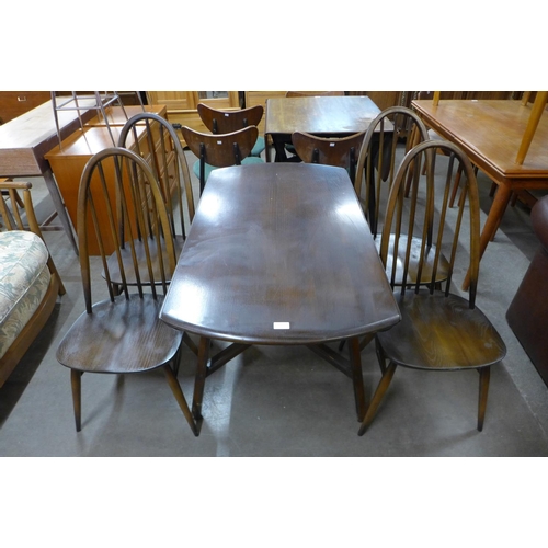 135 - An Ercol dark elm Windsor drop leaf table and four Quaker chairs