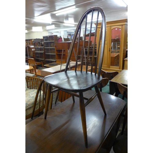 135 - An Ercol dark elm Windsor drop leaf table and four Quaker chairs