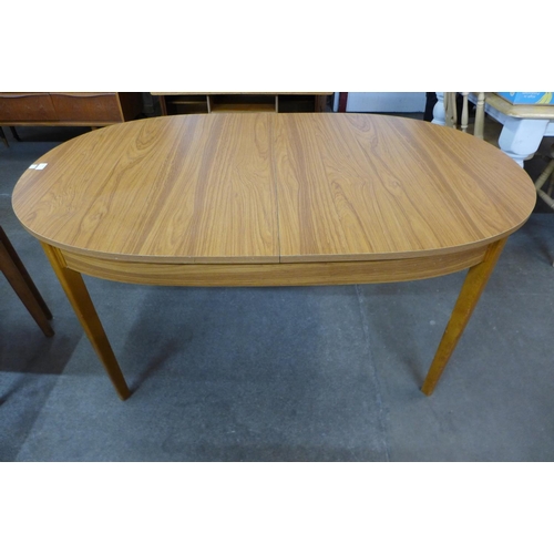 144 - A teak extending dining table