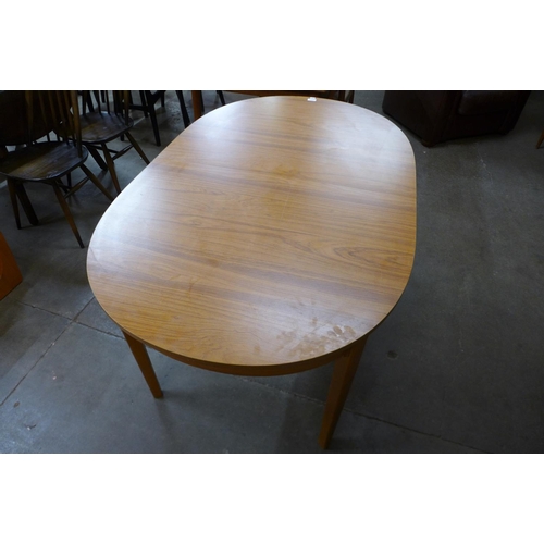 144 - A teak extending dining table