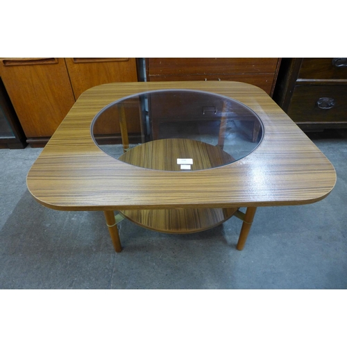 150 - A simulated teak and glass topped coffee table