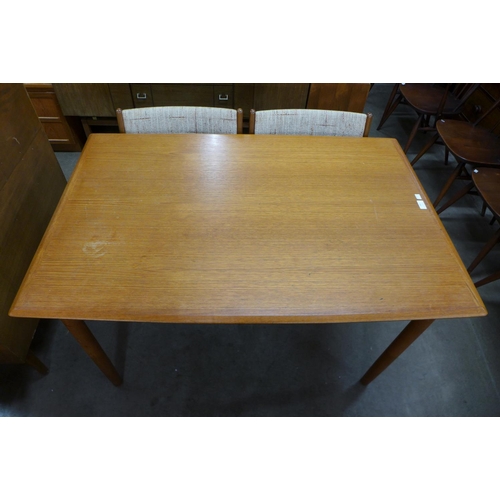 158 - A Danish teak extending dining table and four Eric Buch teak dining chairs